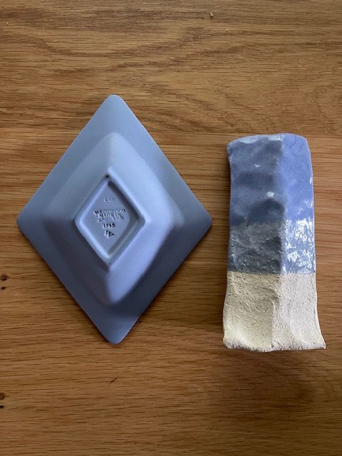A Wedgwood Blue Jasperware dish beside a Ware test tile fired in the matching blue glaze